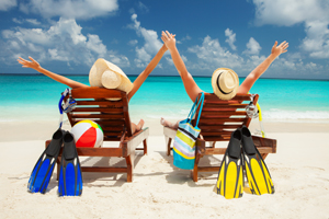 Couple sitting on beach of white sand